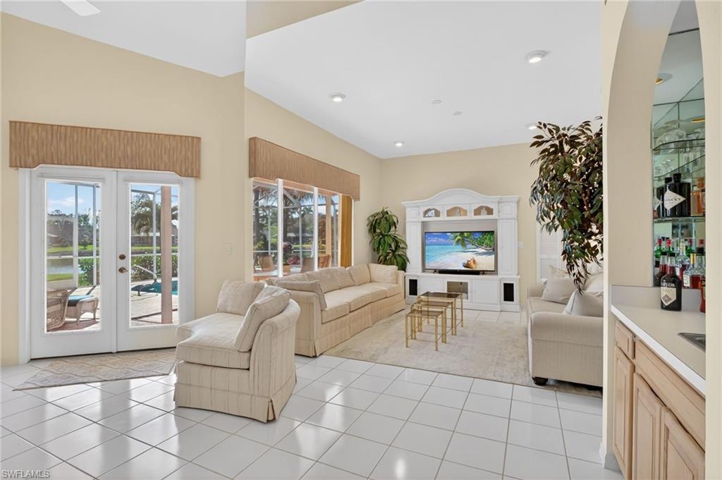 6687 Huntley Lane South Naples, FL 34104 - Photo 16 of 37 a living room with furniture and a large window