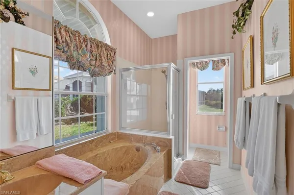 a bath room with a bath tub and a shower