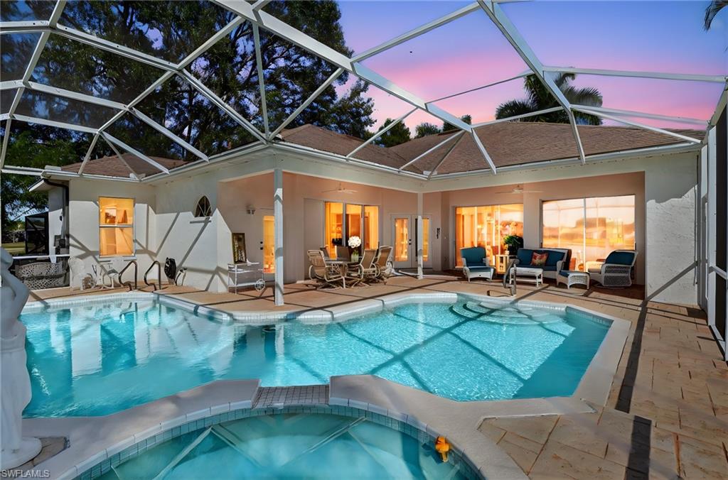 6687 Huntley Lane South Naples, FL 34104 - Photo 2 of 37 a view of a swimming pool with a patio