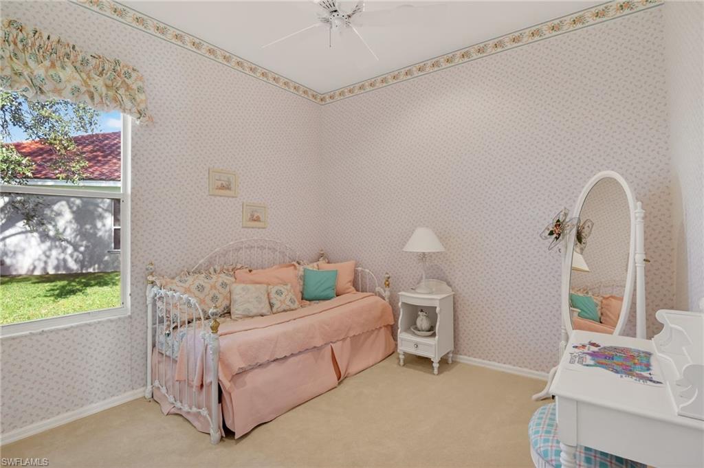 6687 Huntley Lane South Naples, FL 34104 - Photo 25 of 37 a bedroom with a bed and a window