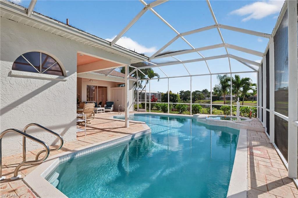 6687 Huntley Lane South Naples, FL 34104 - Photo 28 of 37 a view of a swimming pool with a patio