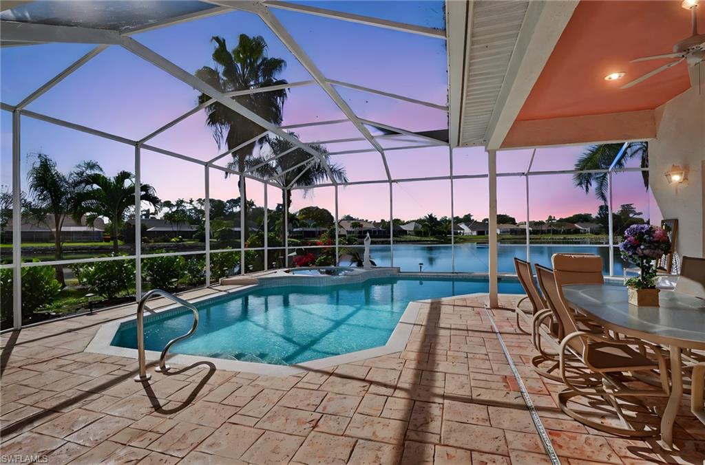 6687 Huntley Lane South Naples, FL 34104 - Photo 3 of 37 a view of a swimming pool with a patio
