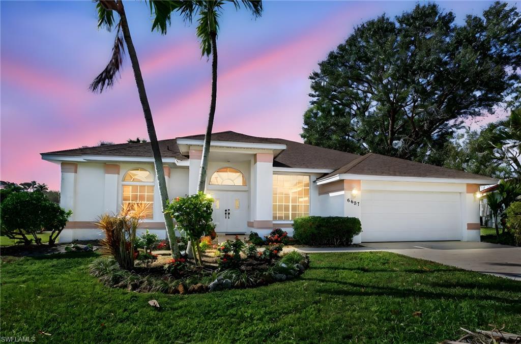 6687 Huntley Lane South Naples, FL 34104 - Photo 5 of 37 a front view of a house with garden