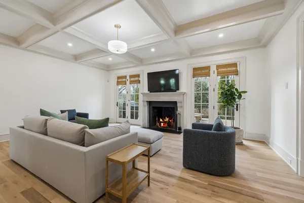 a living room with furniture flat screen tv and a fireplace