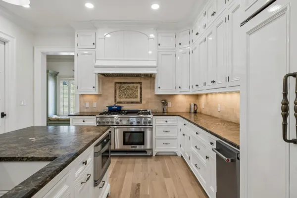 a kitchen with stainless steel appliances granite countertop a stove and a sink