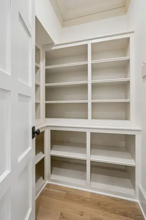 a spacious en suite bathroom with a tub double vanity and mirror