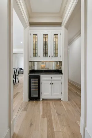 a view of an empty room with cabinet and a window