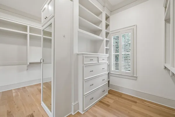a view of walk in closet with empty racks