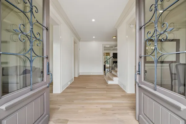 a living room with furniture a clock and a fireplace