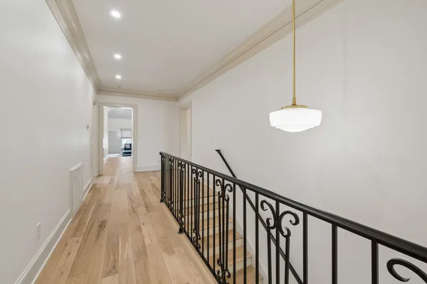 a living room with a fireplace a flat screen tv and a table