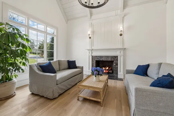 a view of a dining room with furniture a chandelier and wooden floor