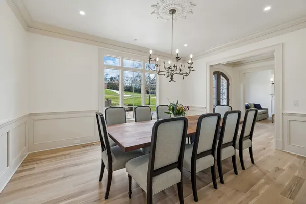 a living room with furniture a large window and a fireplace