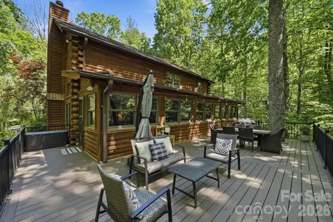 a view of backyard with outdoor seating and plants