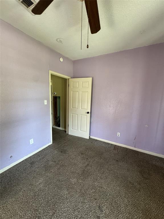 803 Ripley Avenue Ennis, TX 75119 - Photo 37 of 40 Carpeted interior room featuring a white paneled door, ceiling-mounted fan with wooden blades, and recessed lighting