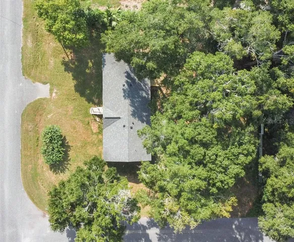 an aerial view of residential houses with outdoor space and swimming pool