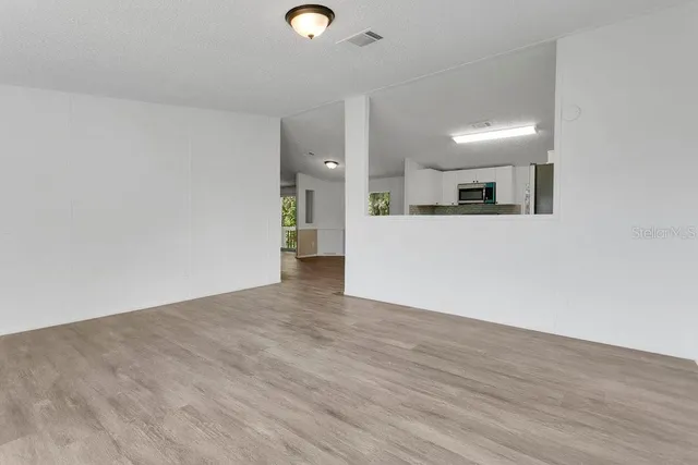 a view of a kitchen with a sink and a refrigerator