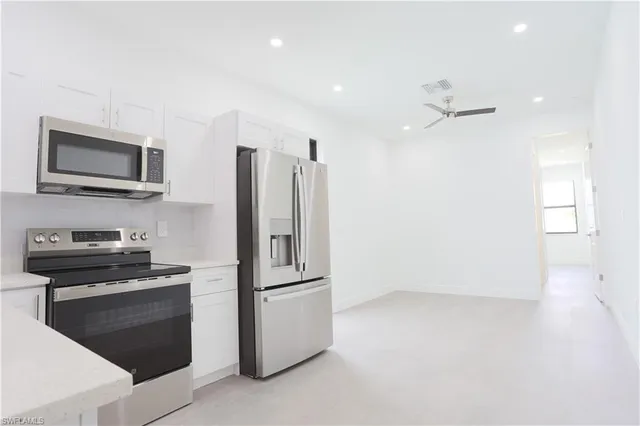 a kitchen with cabinets and stainless steel appliances