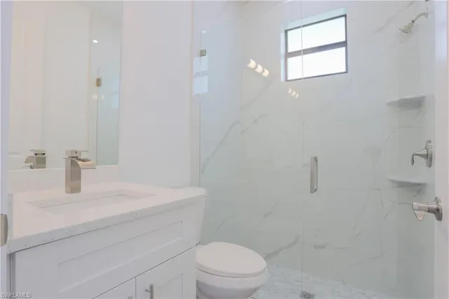 a view of backyard with potted plants and a large tree