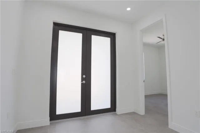 an empty room with a cabinet and a flat screen tv