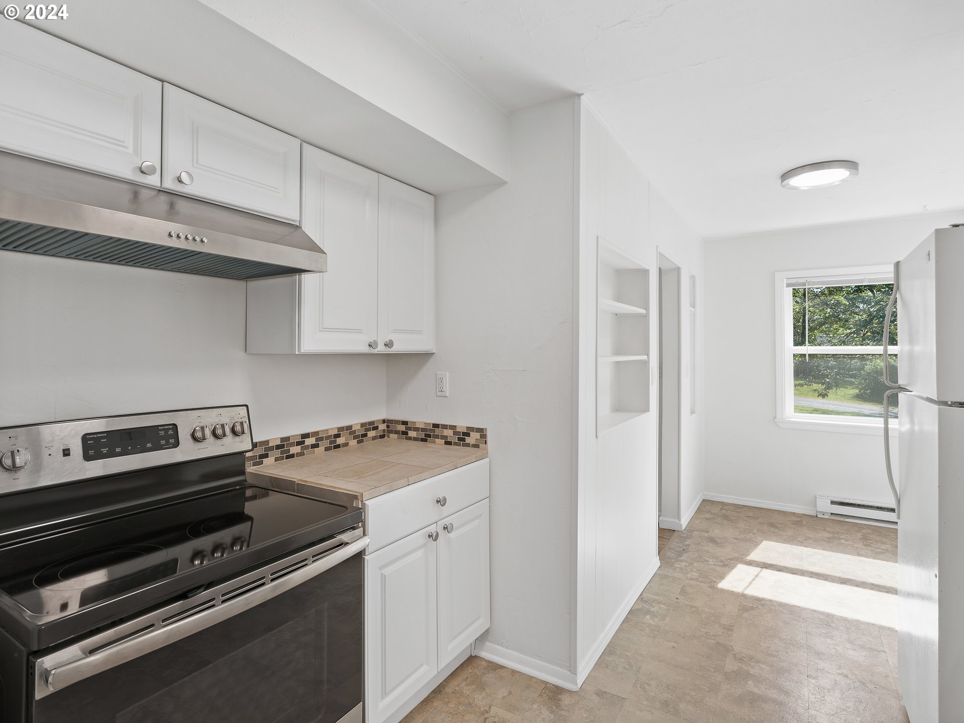 2311 Southwest 6th Avenue, Unit 6 Camas, WA 98607 - Photo 17 of 32 a kitchen with appliances a stove and cabinets