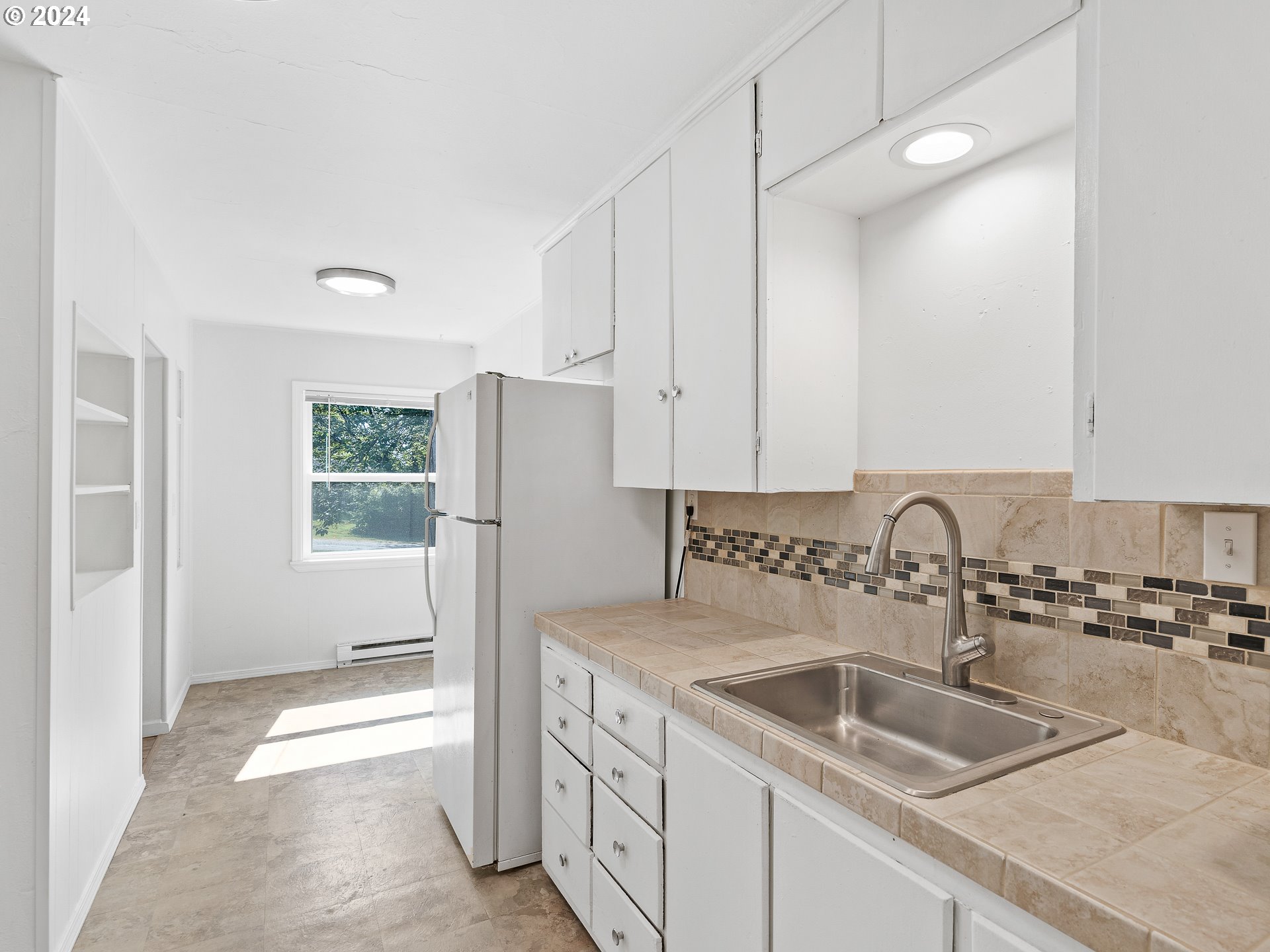 2311 Southwest 6th Avenue, Unit 6 Camas, WA 98607 - Photo 18 of 32 a kitchen with a sink and a refrigerator