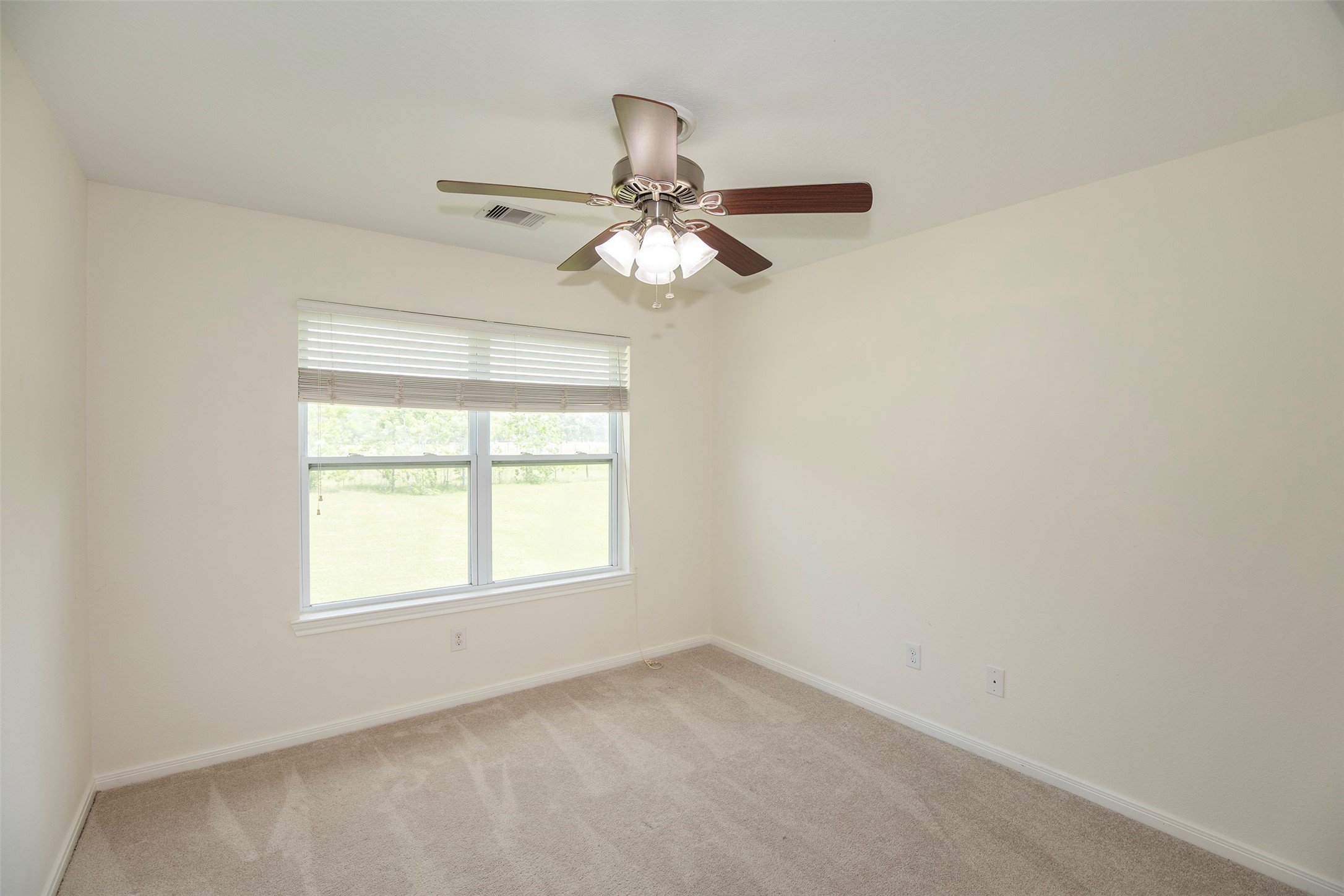 6105 Del Bello Boulevard Manvel, TX 77578 - Photo 25 of 37 an empty room with a window and a fan