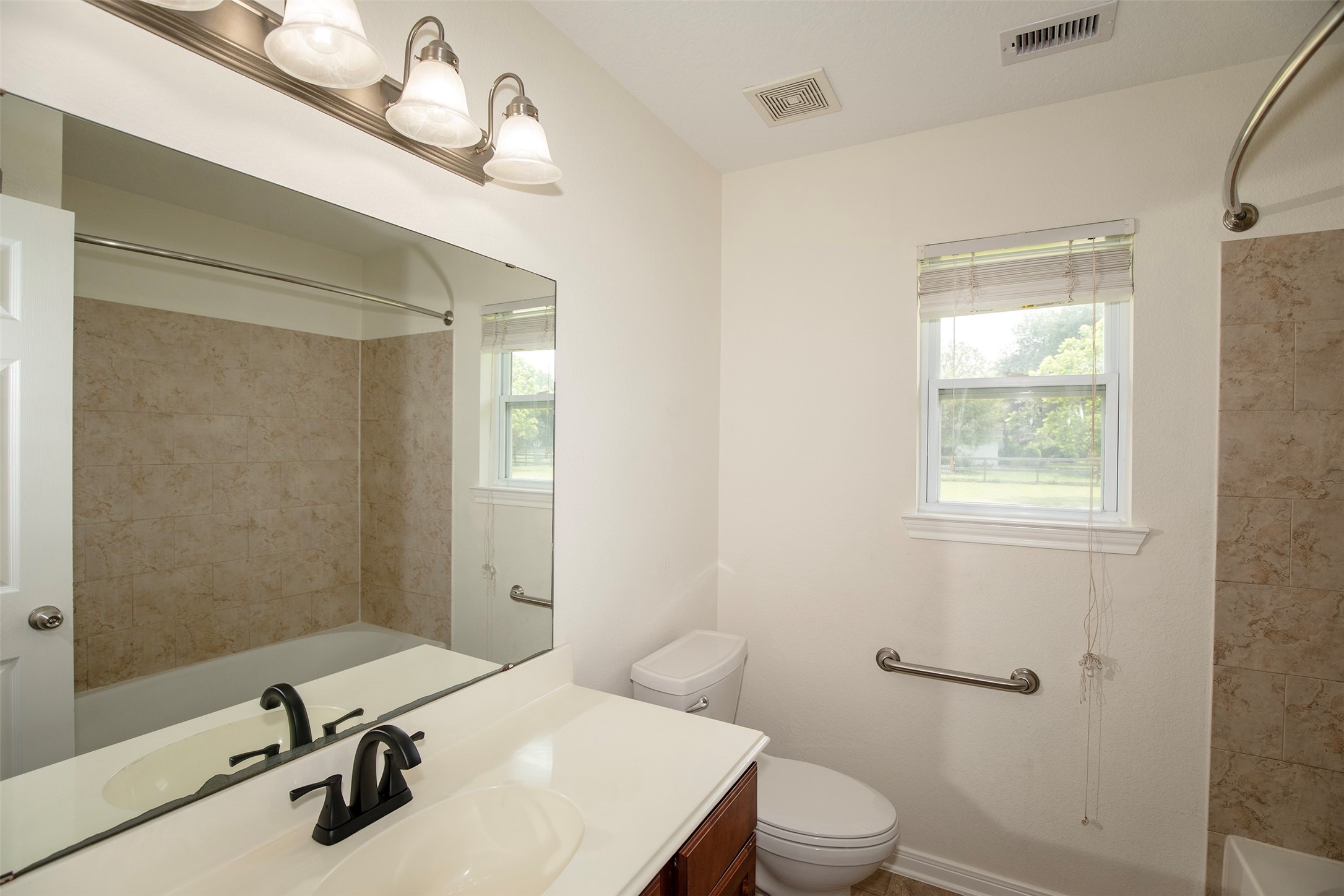 6105 Del Bello Boulevard Manvel, TX 77578 - Photo 27 of 37 a bathroom with a sink a toilet and shower