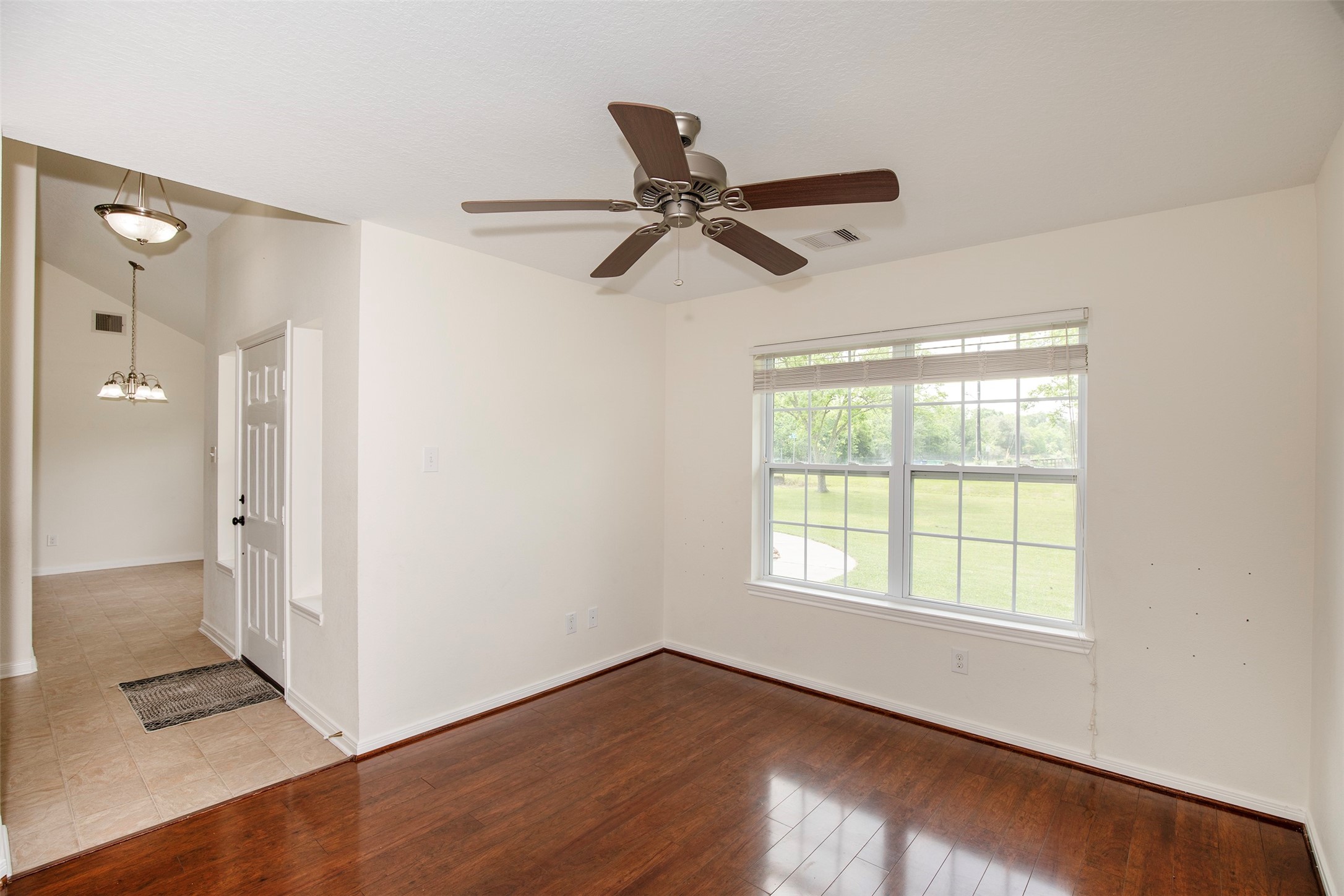 6105 Del Bello Boulevard Manvel, TX 77578 - Photo 7 of 37 a view of an empty room with wooden floor and a window