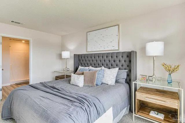 a bedroom with a bed and a dresser