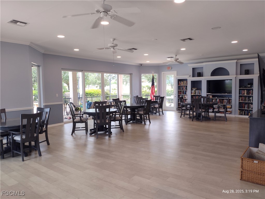 4709 Fairloop Run Lehigh Acres, FL 33973 - Photo 12 of 25 a view of a dining room with furniture window and wooden floor