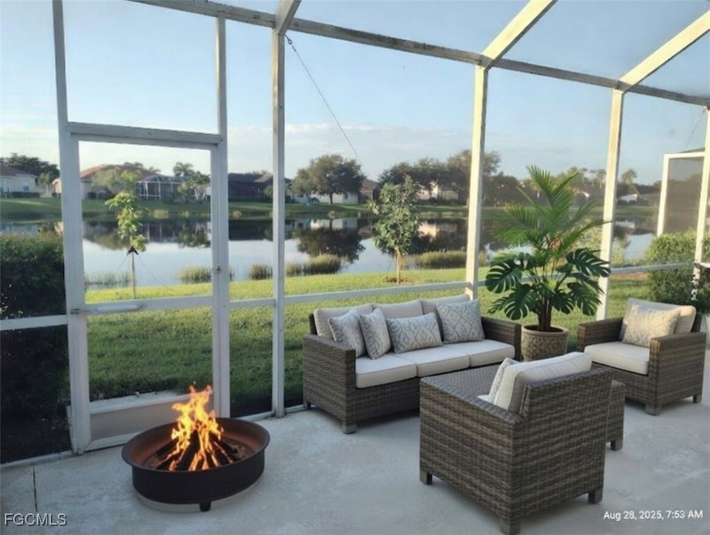 4709 Fairloop Run Lehigh Acres, FL 33973 - Photo 3 of 25 a living room with couch a yard and a floor to ceiling window