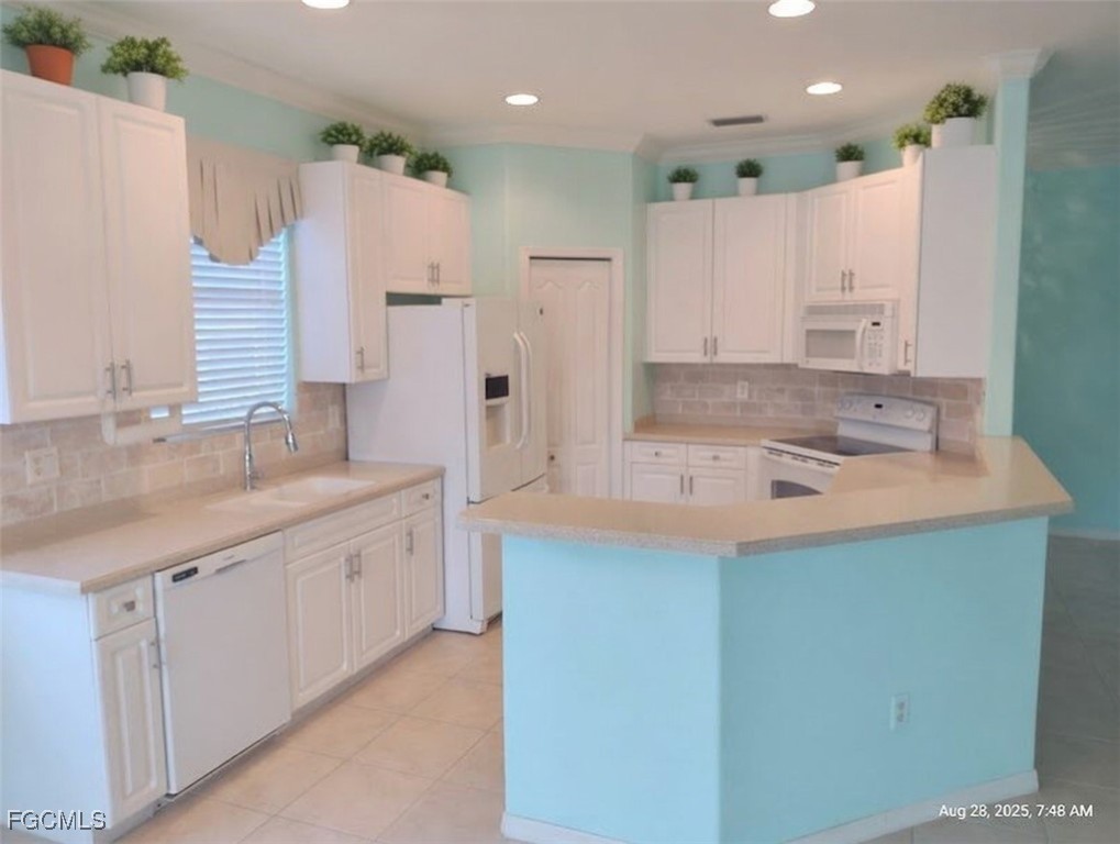 4709 Fairloop Run Lehigh Acres, FL 33973 - Photo 5 of 25 a kitchen with granite countertop a sink and a refrigerator