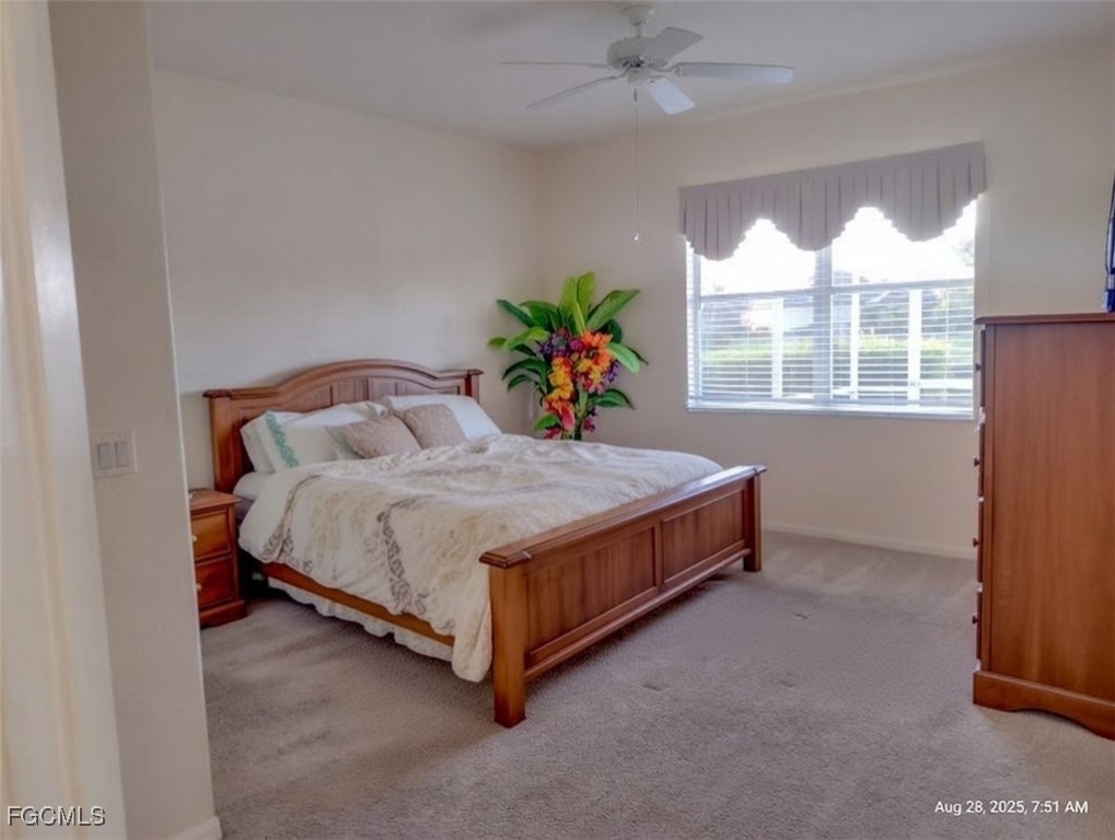 4709 Fairloop Run Lehigh Acres, FL 33973 - Photo 7 of 25 a bed sitting in a room next to a window