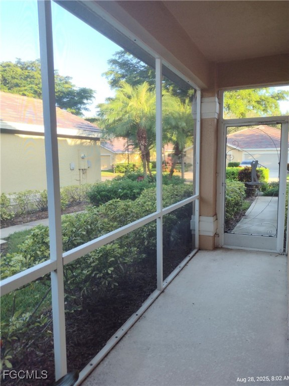 4709 Fairloop Run Lehigh Acres, FL 33973 - Photo 10 of 25 a view of a glass door and wooden floor