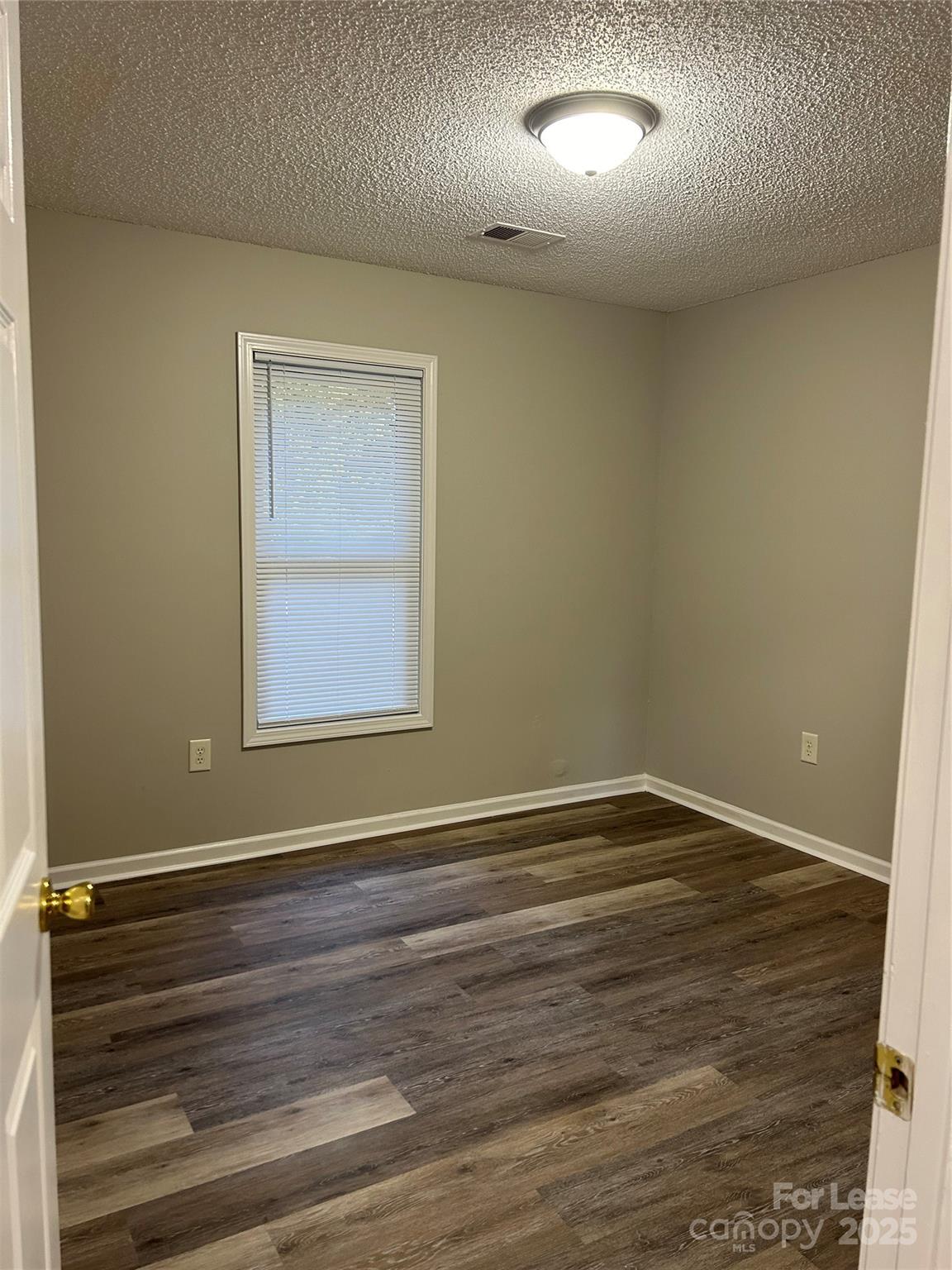 108 Bryans Way Lincolnton, NC 28092 - Photo 2 of 9 a view of an empty room with wooden floor and a window