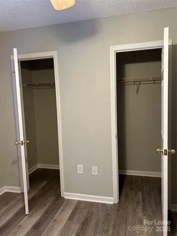 an empty room with wooden floor and closet