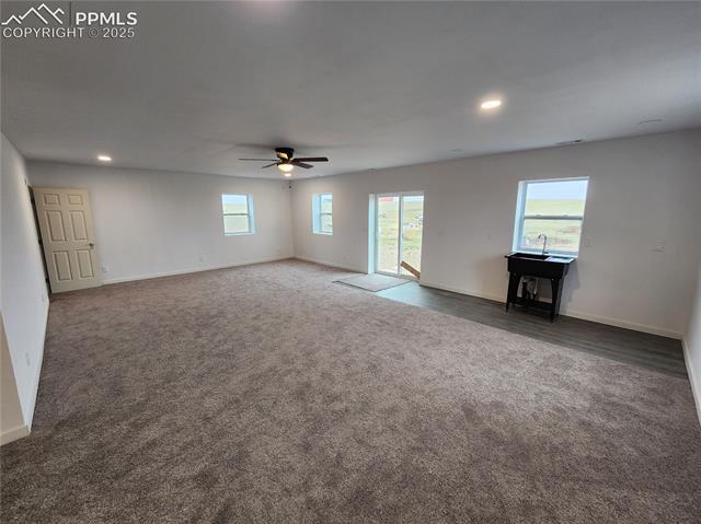 32174 Torrence Road Yoder, CO 80864 - Photo 10 of 13 Unfurnished living room with recessed lighting, baseboards, ceiling fan, and carpet floors