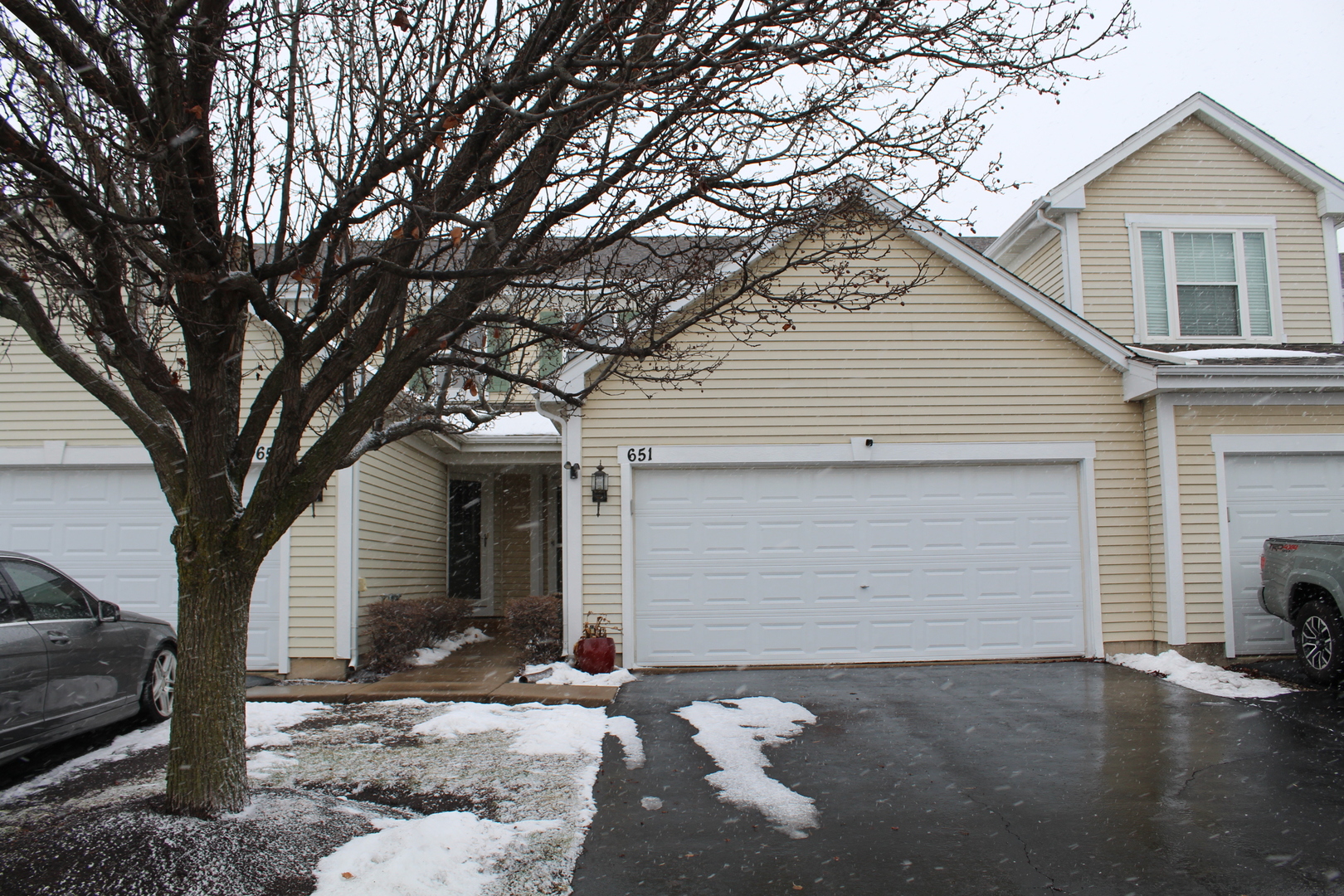 a front view of a house with a yard and garage