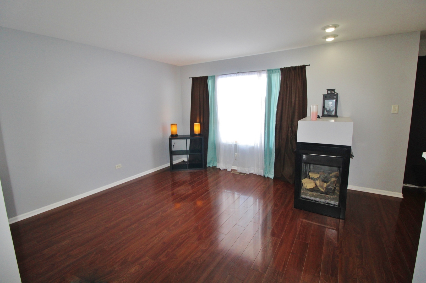 651 Chestnut Ridge Minooka, IL 60447 - Photo 13 of 33 wooden floor in an empty room with a window