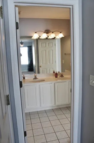 a bathroom with a granite countertop toilet and a sink