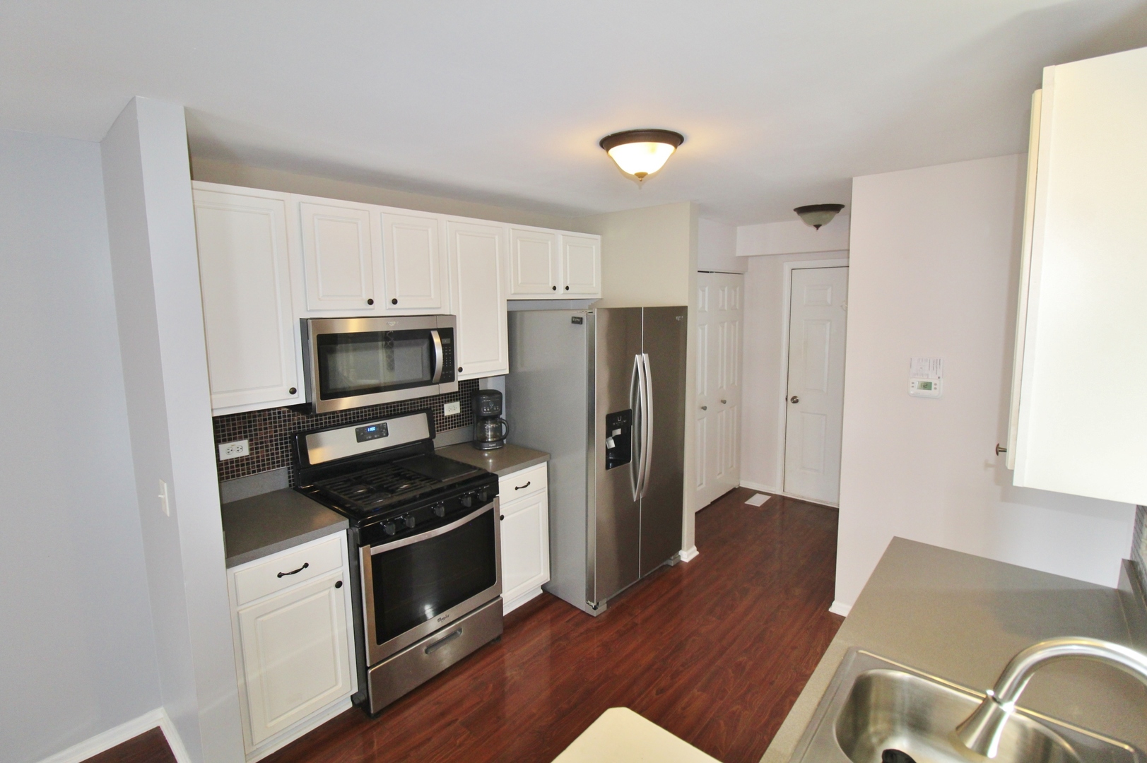 651 Chestnut Ridge Minooka, IL 60447 - Photo 5 of 33 a kitchen with stainless steel appliances a refrigerator stove and sink