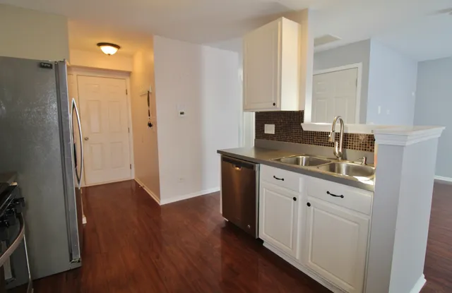 a kitchen with a sink and a mirror