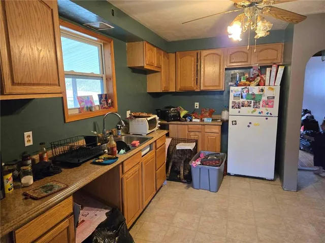 a kitchen with stainless steel appliances a sink stove and refrigerator