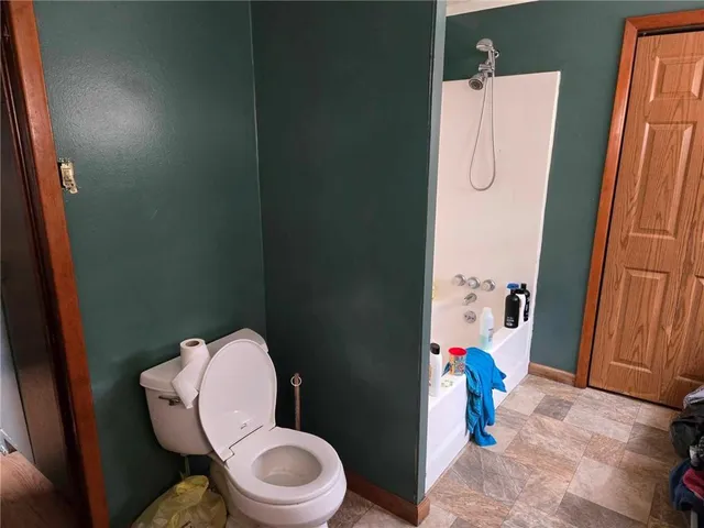 a bathroom with a toilet and shower