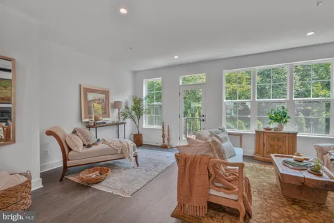 a bedroom with bed couch and window