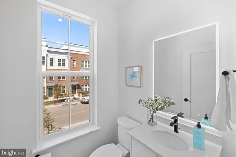 a bathroom with a sink a toilet and a mirror