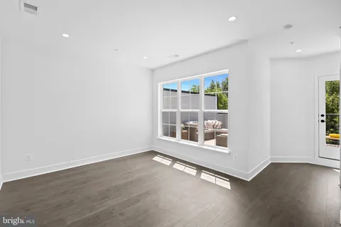a bathroom with a granite countertop sink a toilet and shower