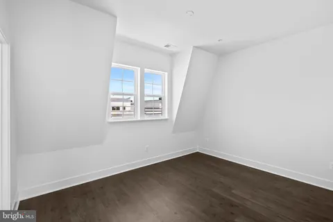 a view of a patio with couches table and chairs and potted plants with wooden floor and fence
