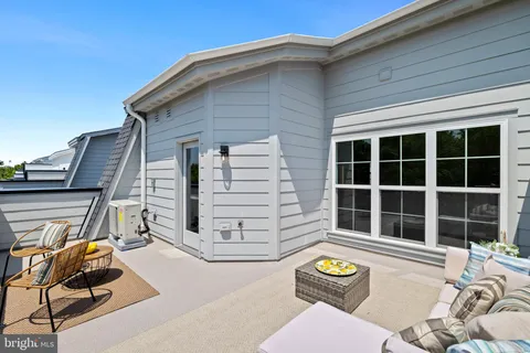 a living room with furniture and a entryway