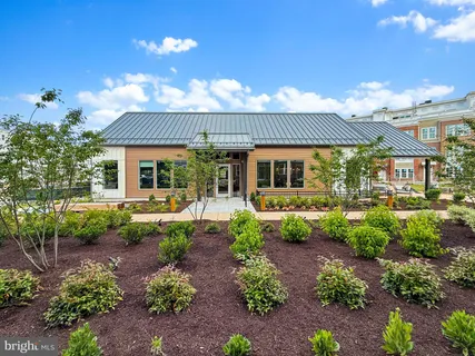 a front view of a building with large trees